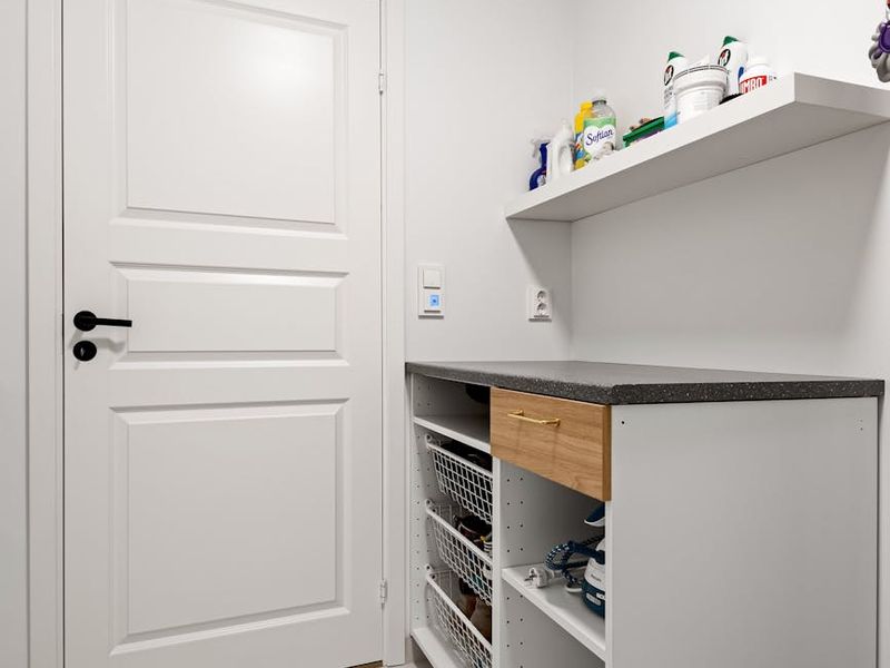 Minimalist living room with organized shelving and clean design